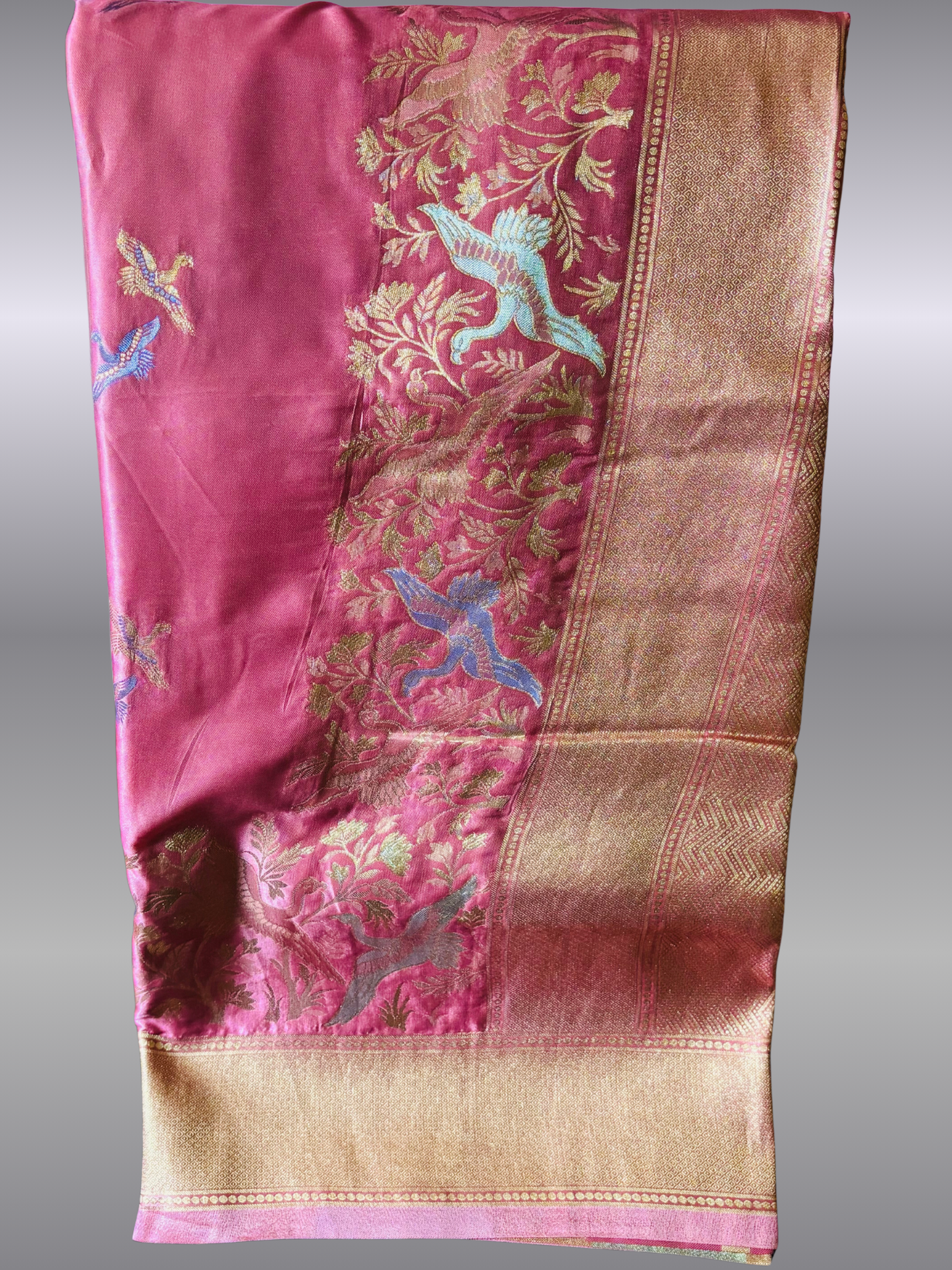 Elegant Rivayat muslin satin silk saree with soft sheen, fluid drape, and matching unstitched blouse. Perfect for weddings, festive wear, and graceful evening occasions